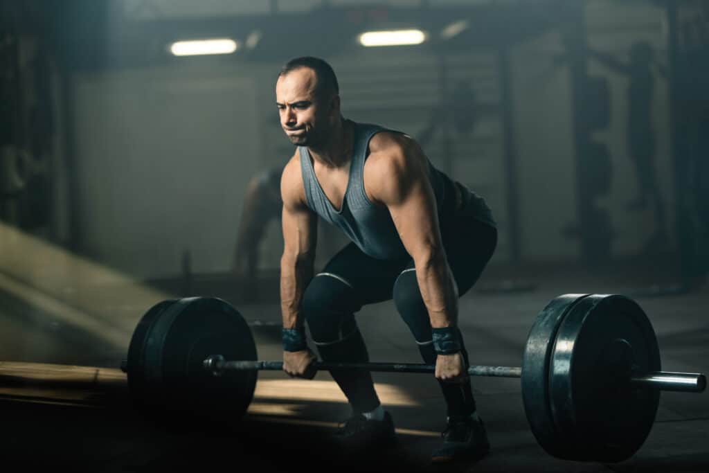 man deadlifting barbell