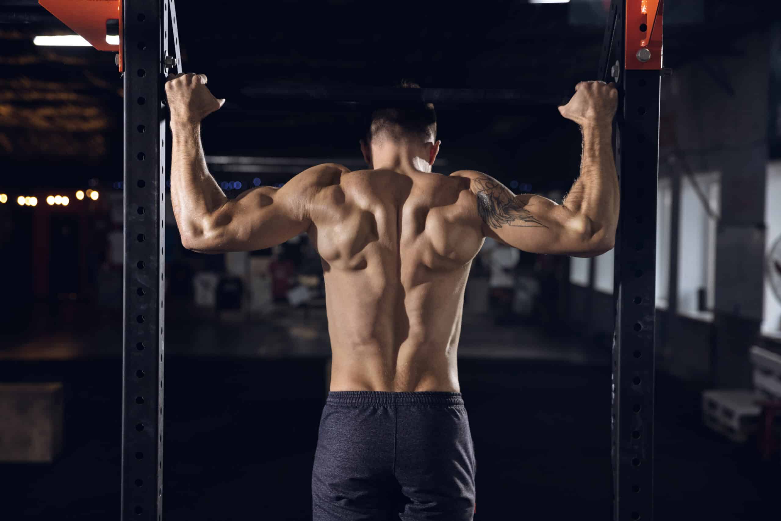 man performing pull-ups at the gym