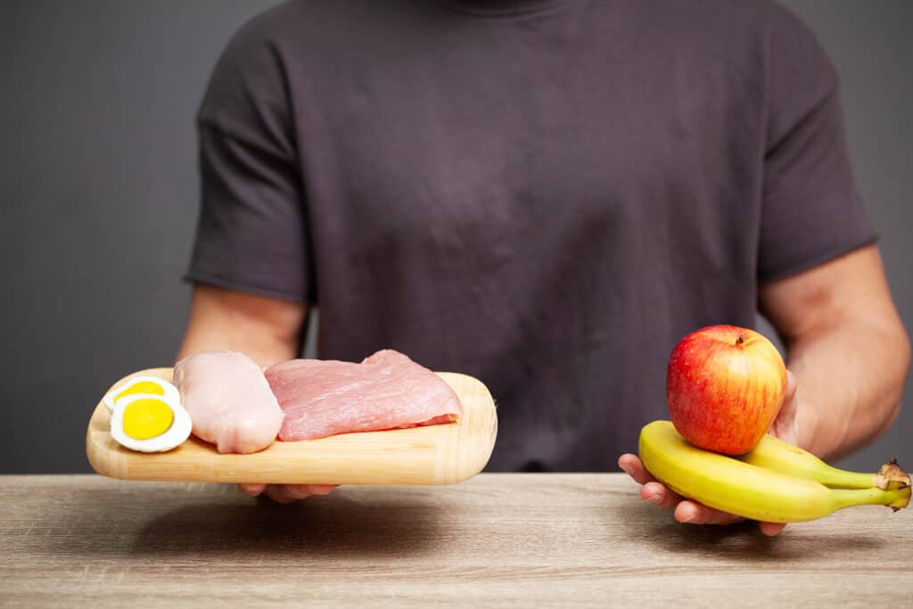 man holding high protein food and healthy fruits