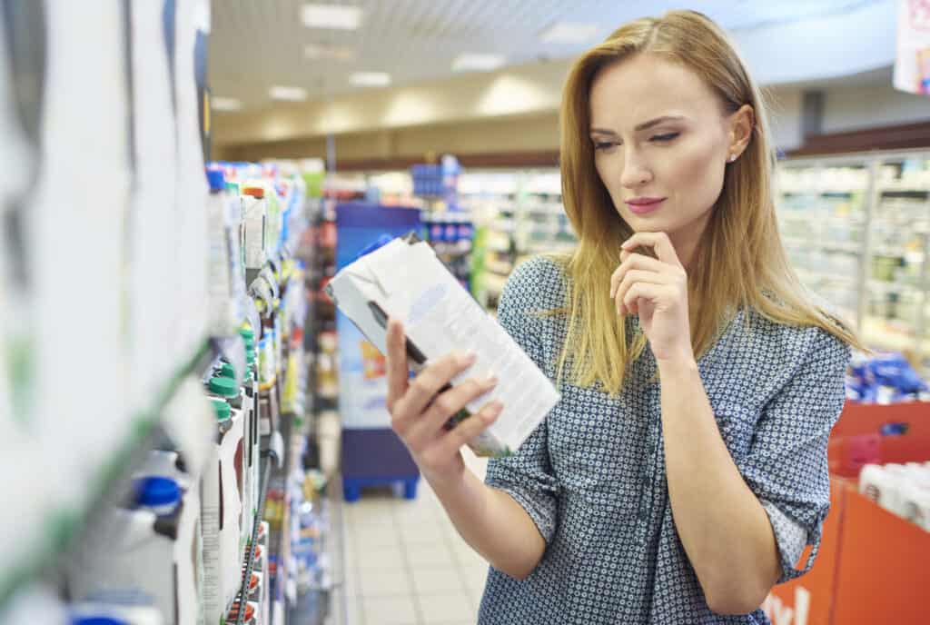 woman reading nutrition labels