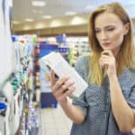 woman reading nutrition labels
