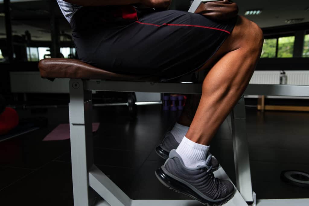 man working on calves at the gym