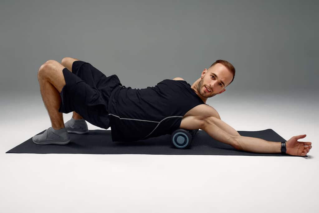man using foam roller to release tension post workout