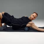 man using foam roller to release tension post workout