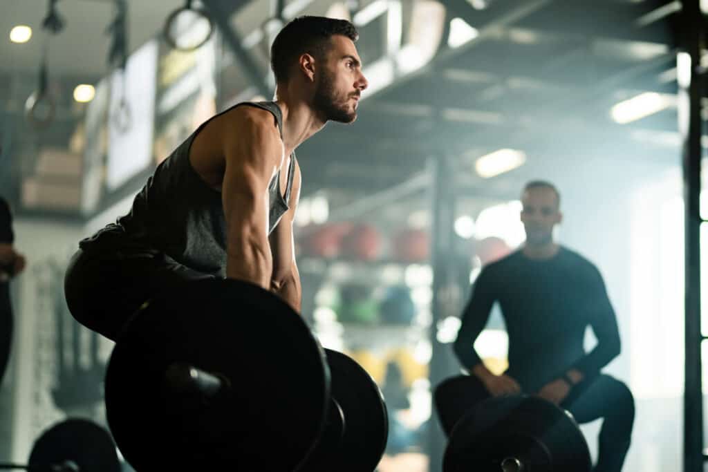 man performing deadlift with a barbell