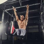 man performing hanging ab exercises