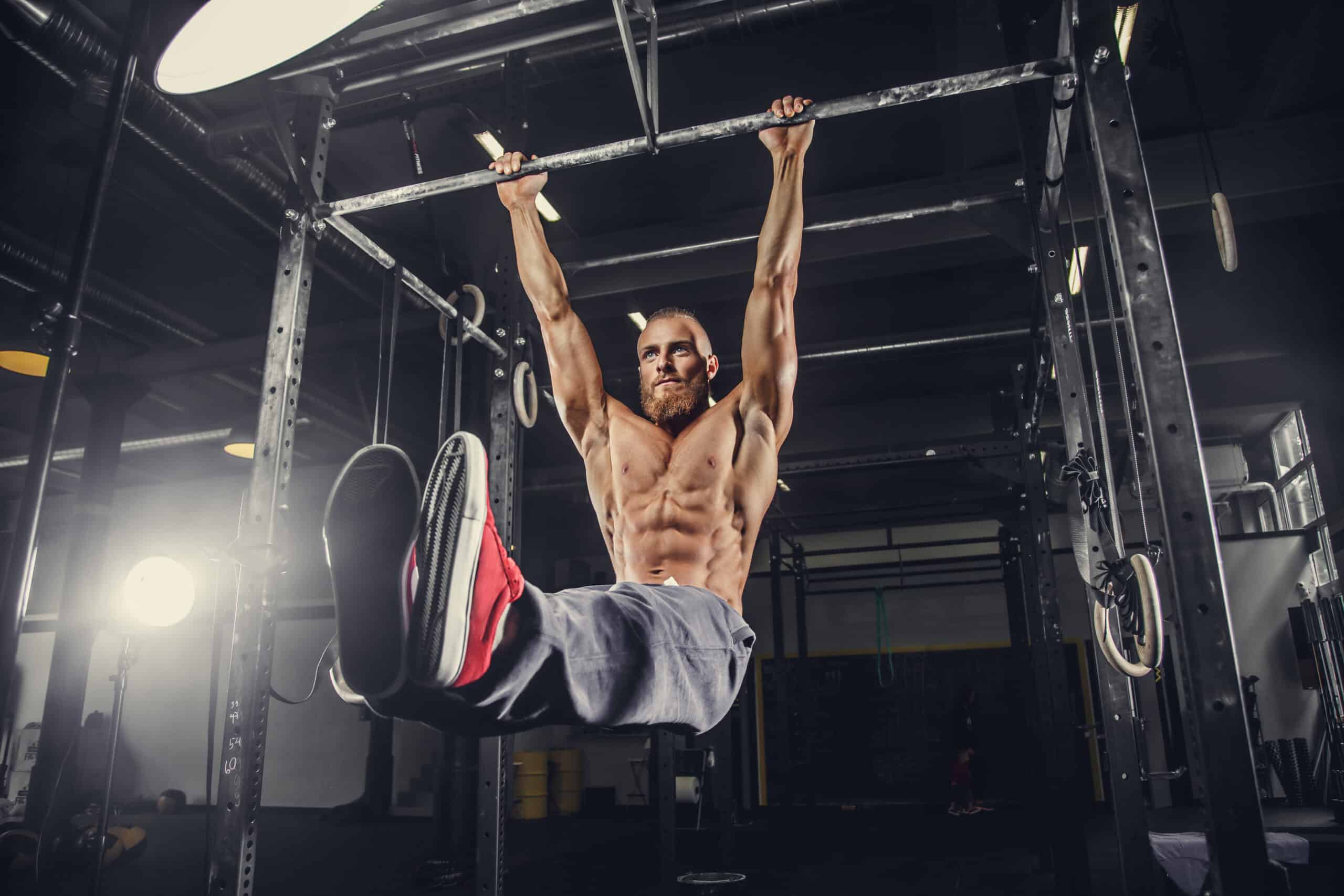 man performing hanging ab exercises