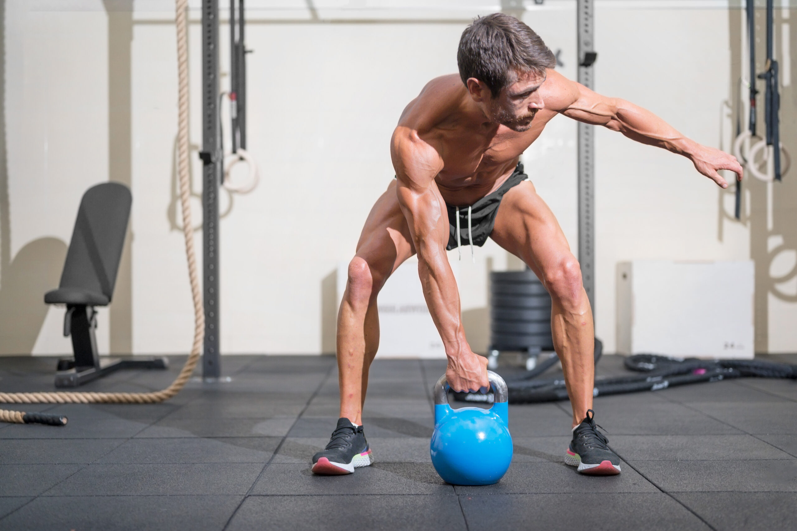 man working out at the gym with a kettlebell