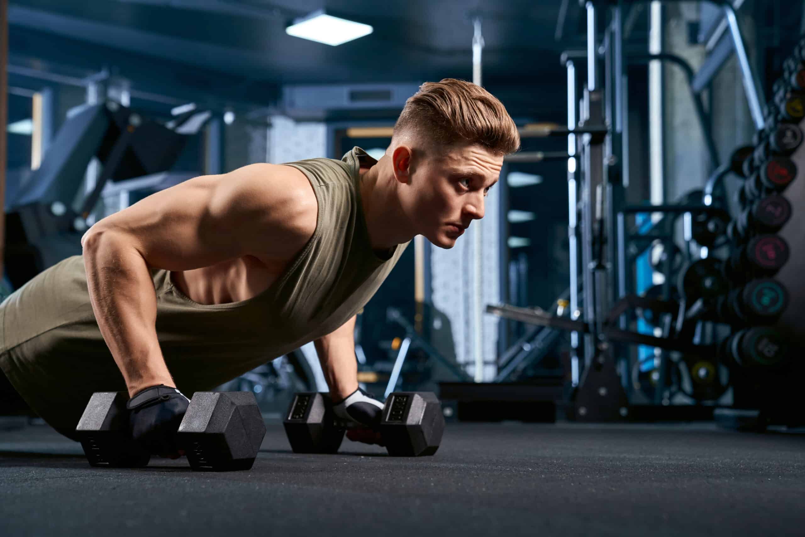 man doing deep dumbbell pushups