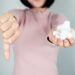 woman holding sugar and signaling thumbs down